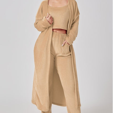 Woman wearing a beige outfit with a matching cardigan on a white background