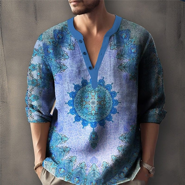 Man wearing a blue and green patterned shirt with a mandala design against a gray background