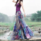 Woman wearing a colorful long skirt with a blurred natural background