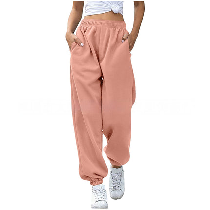 Person wearing pink sweatpants and white sneakers on a white background
