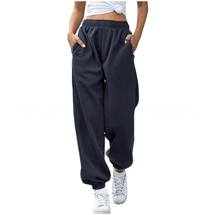 Person wearing navy blue baggy pants on a white background