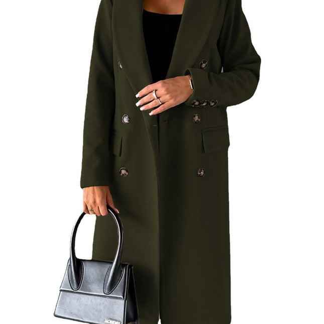 Person wearing a long green coat holding a black handbag on a white background
