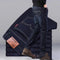 Dark blue jeans with a leather patch on a gray background