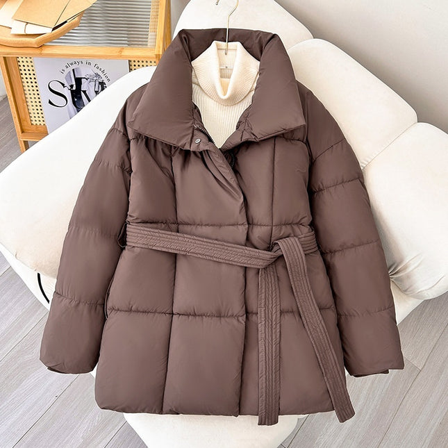Brown puffer jacket with a belt on a white chair