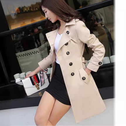 Woman wearing a beige trench coat in an indoor setting