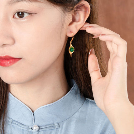 Girl wearing gold vintage earrings with cartoon and geometric designs, lightweight and elegant accessory for daily wear.