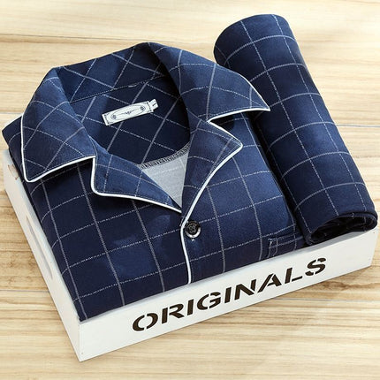 Blue checkered shirt with rolled-up sleeve on a white 'ORIGINALS' box on a wooden surface