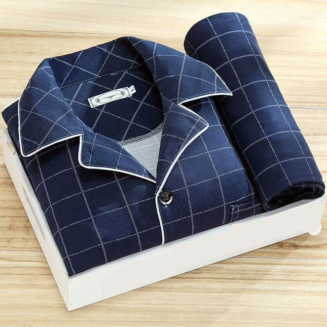 Blue checkered shirt with rolled-up sleeve on a white 'ORIGINALS' box on a wooden surface