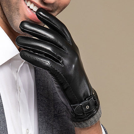 Person wearing a black leather glove on a beige background