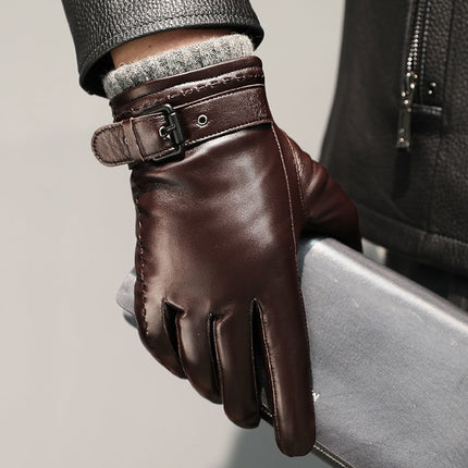 Brown leather glove with a buckle on a neutral background