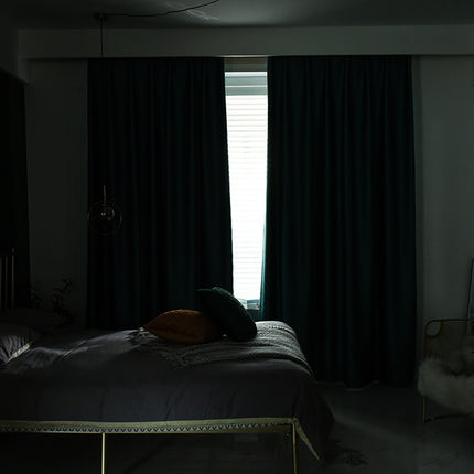 Dark bedroom with bed and curtains
