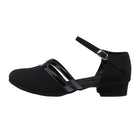 Black dance shoe with a strap on a white background