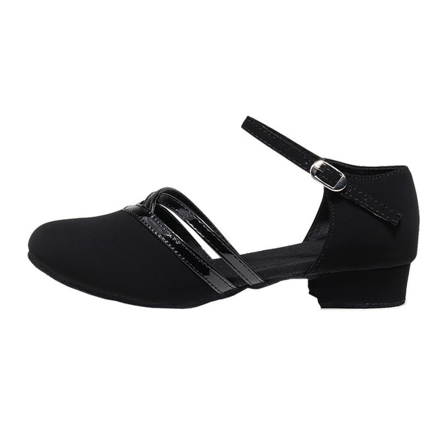 Black dance shoe with a strap on a white background