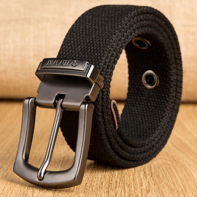 Black belt with a silver buckle on a wooden surface