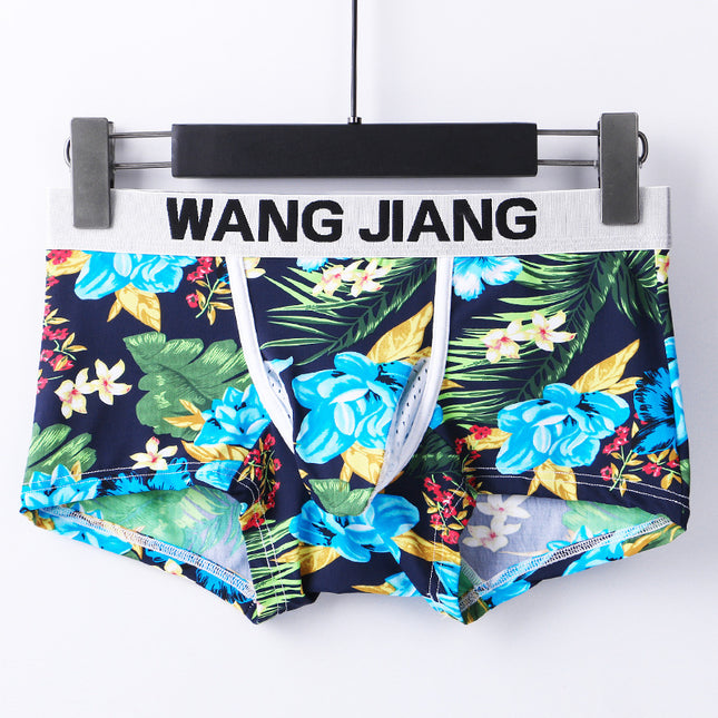 Floral-patterned shorts on a hanger with 'WANG JIANG' branding.