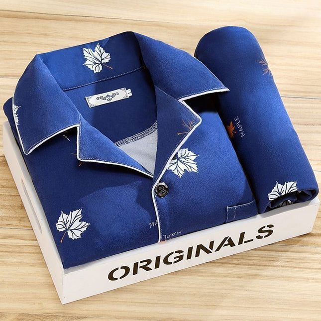 Blue pajama set with leaf patterns on a white box labeled 'ORIGINALS' on a wooden surface.