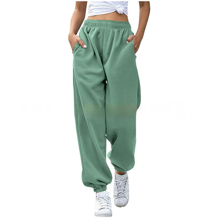 Green baggy pants worn by a person on a white background