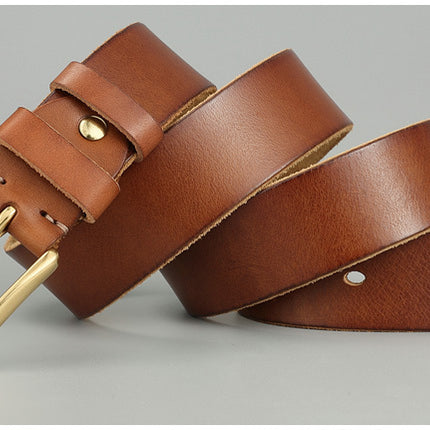 Brown leather belt with gold buckle on a gray background