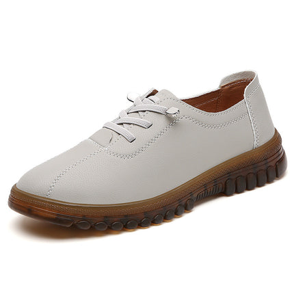 White shoe with brown sole on a white background