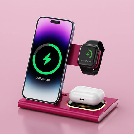 Wireless charging stand with smartphone, smartwatch, and earbuds on a pink background