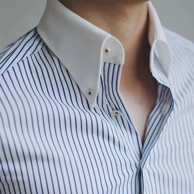 Close-up of a person wearing a white shirt with blue vertical stripes.