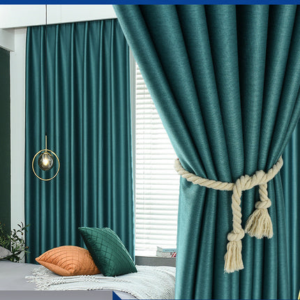 Teal curtains with a decorative tieback in a room setting.