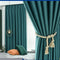 Teal curtains with a decorative tieback in a room setting.