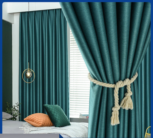 Teal curtains with a decorative tieback in a room setting.