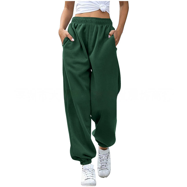 Green baggy pants worn by a person on a white background