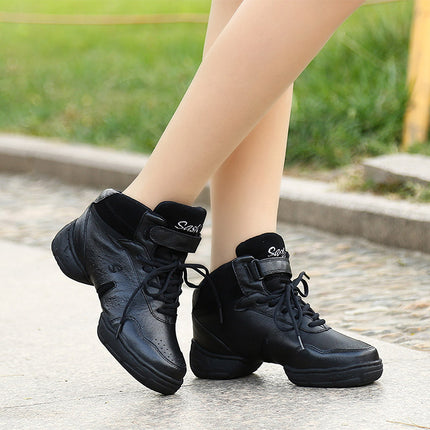Black sneakers worn outdoors on a stone surface with grass in the background