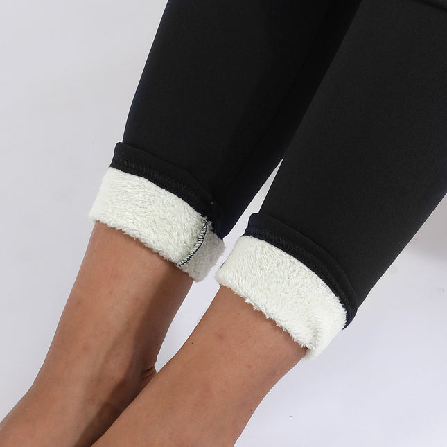Black leggings with white cuffs worn by a person on a light gray background